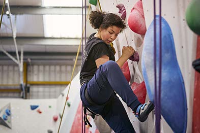 a young girl rock climbing tenaciously