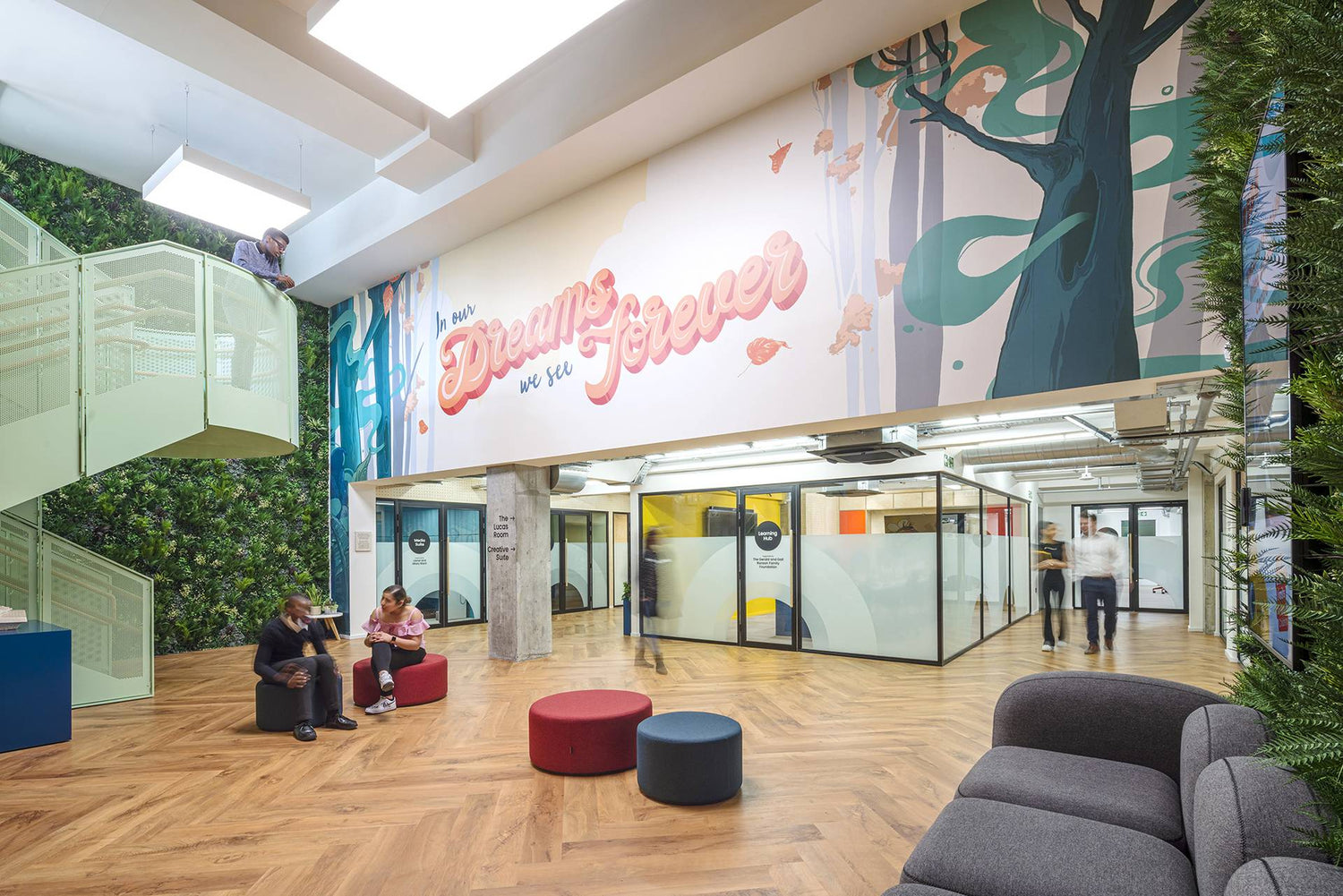 The atrium of our Life Without Limits Centre, with vibrant colours and greenery, and a sign that reads 'in our dreams we see forever