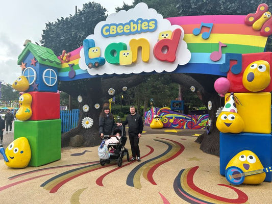 Anthony and his family standing outside the CBeebies Land entrance. 