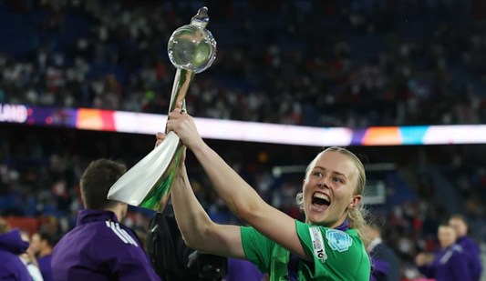 Hannah Hampton, England goalkeeper, looking ecstatic as she holds the European Cup up high in front of the crowd after the team's success