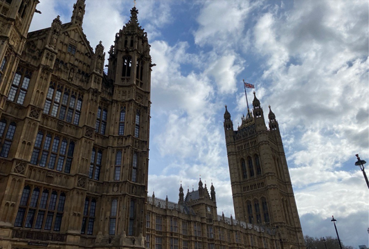 The Houses of Parliament, set against a blue sky with lots of white clouds.
