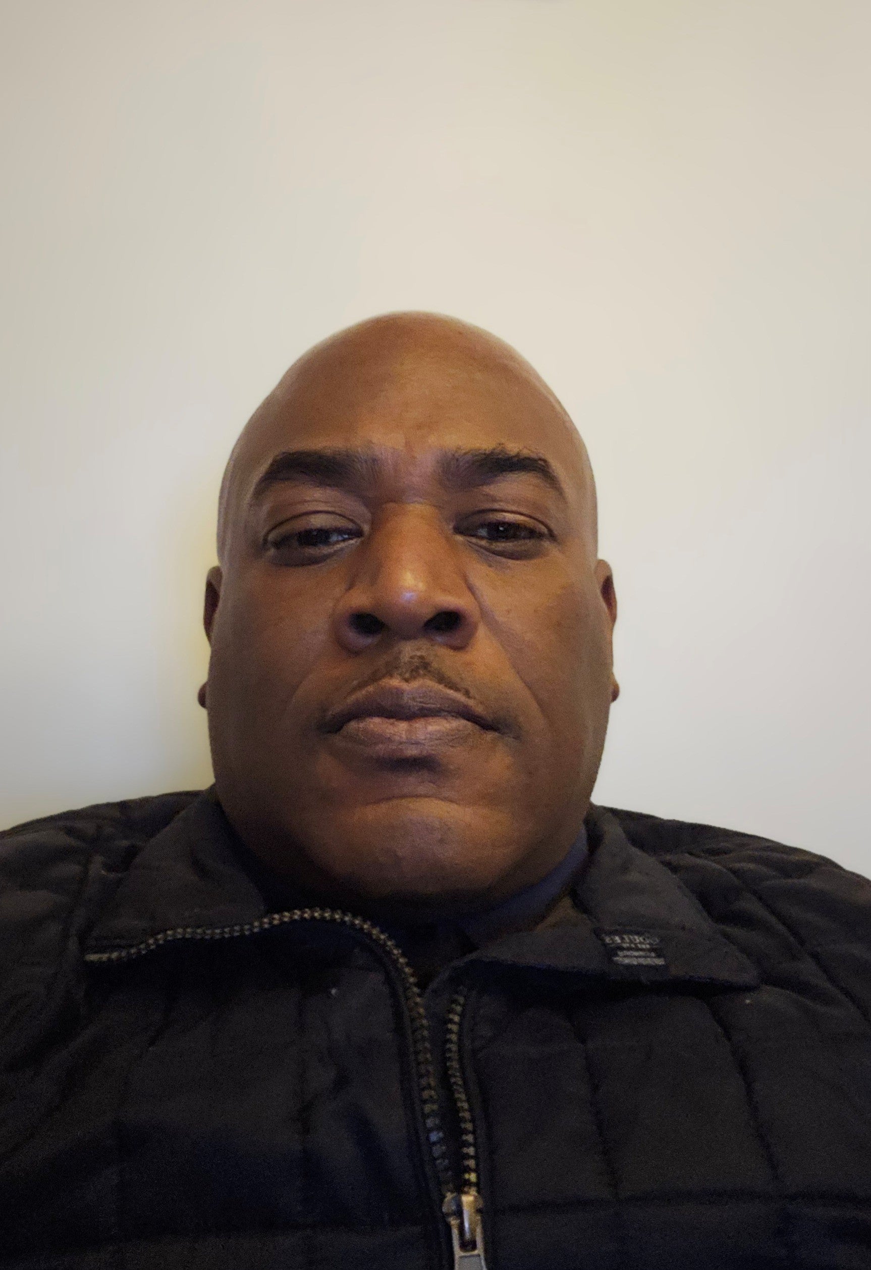 Francis, a man wearing a black jacket against a plain background.