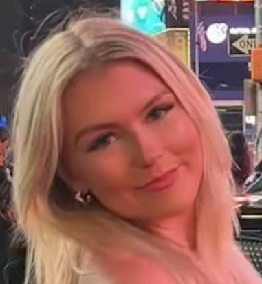 Isabelle, a woman with blonde hair with her head titled slightly to the right smiling at the camera.