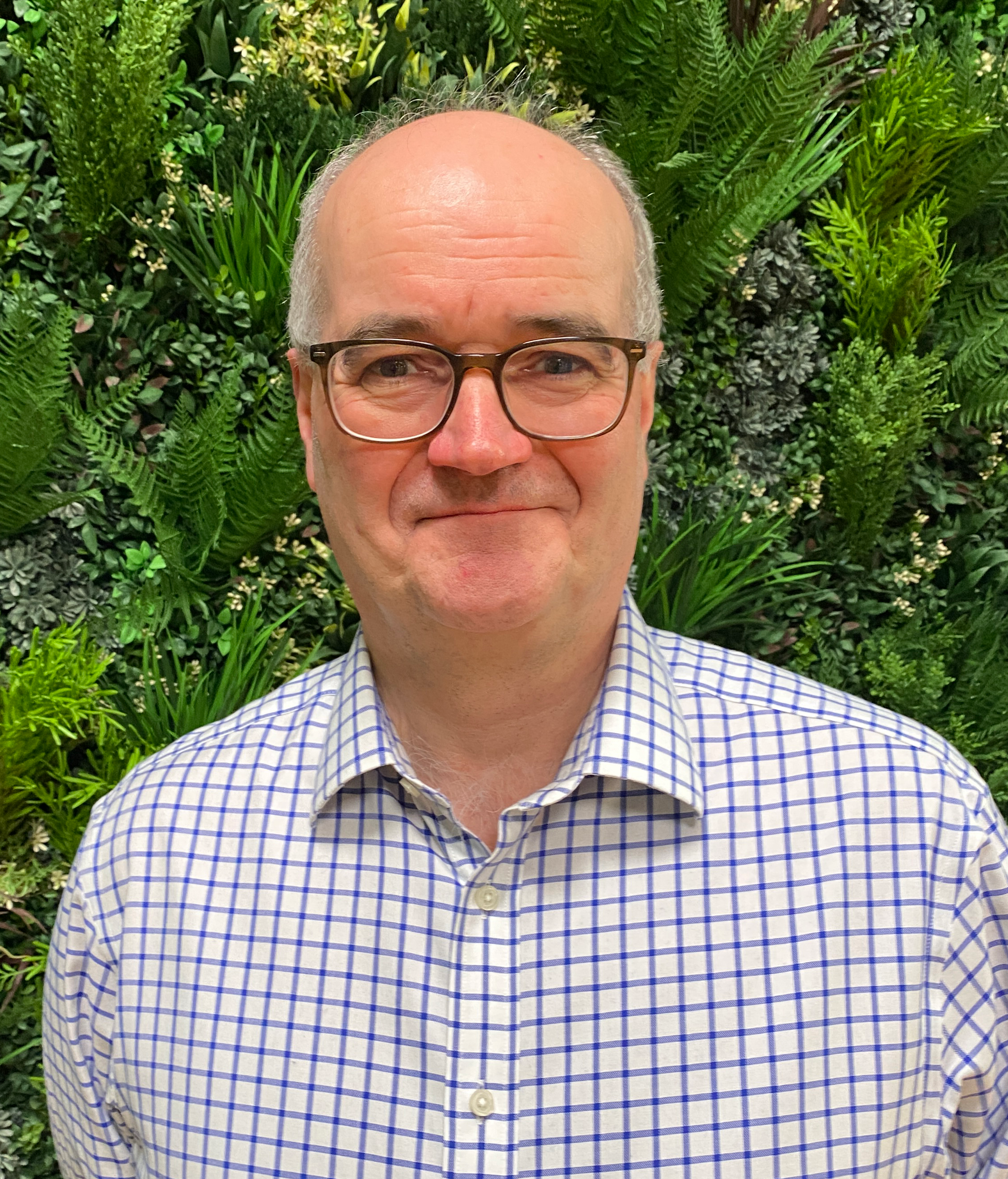 A man with glasses and a plaid shirt