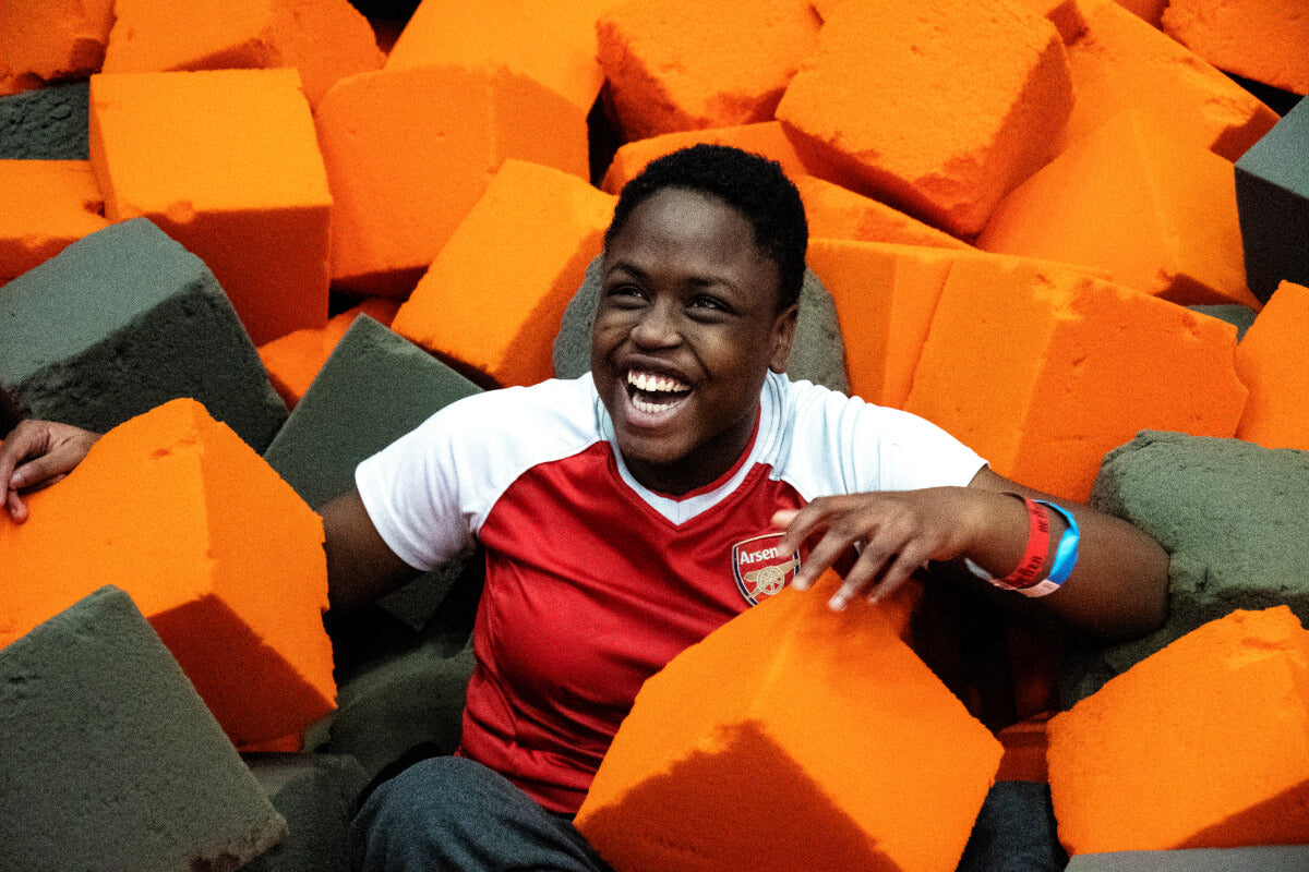 a young person smiling in a football shirt