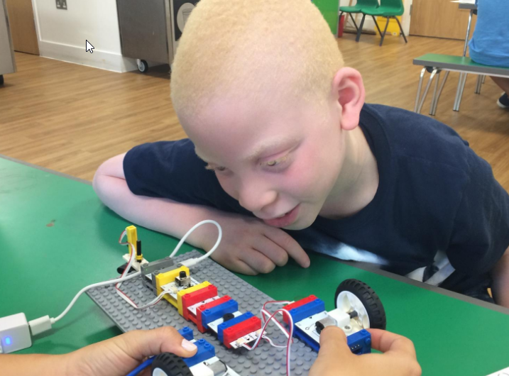 An image of a kid playing with a circuit