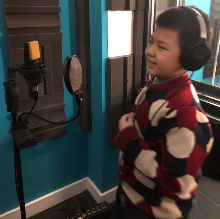 Boy in a soundbooth