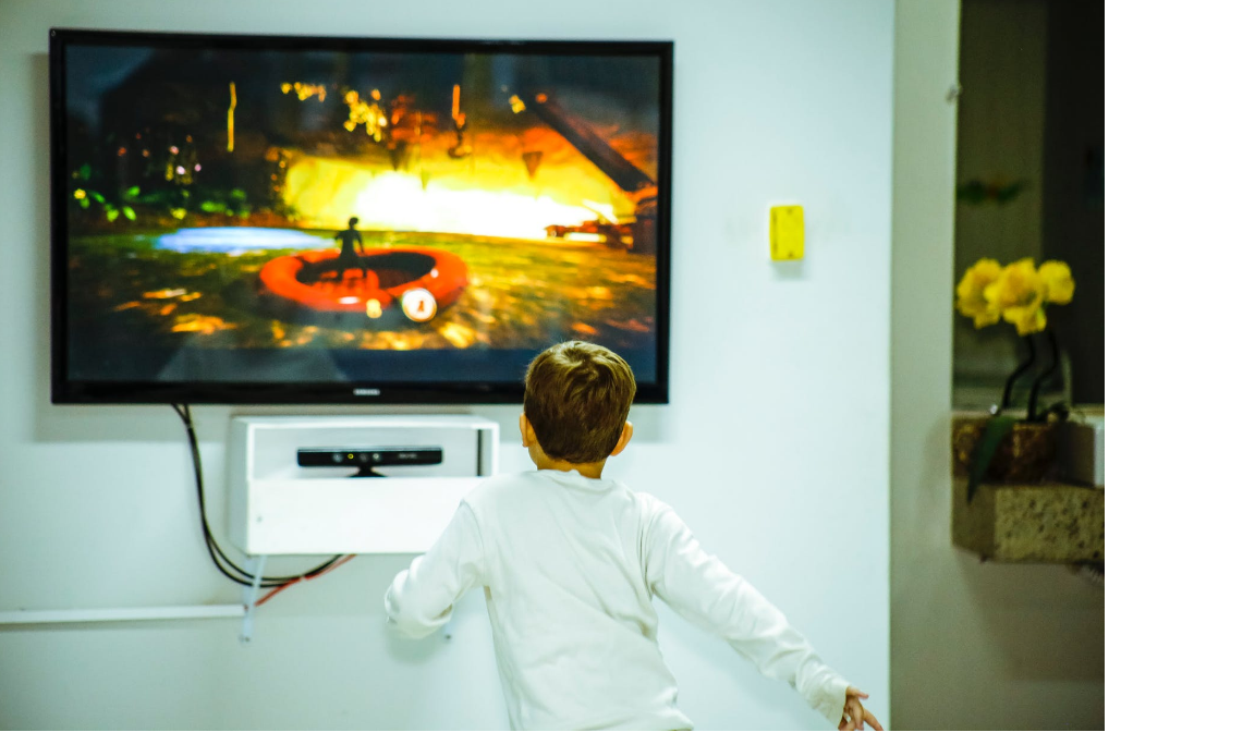 A boy looking at a mounted television