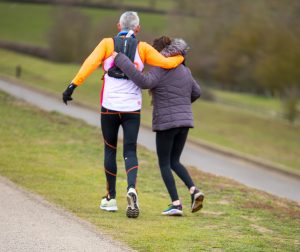 Steven is pictured on his run with a lady alongside him. They have an arm round each other in support.