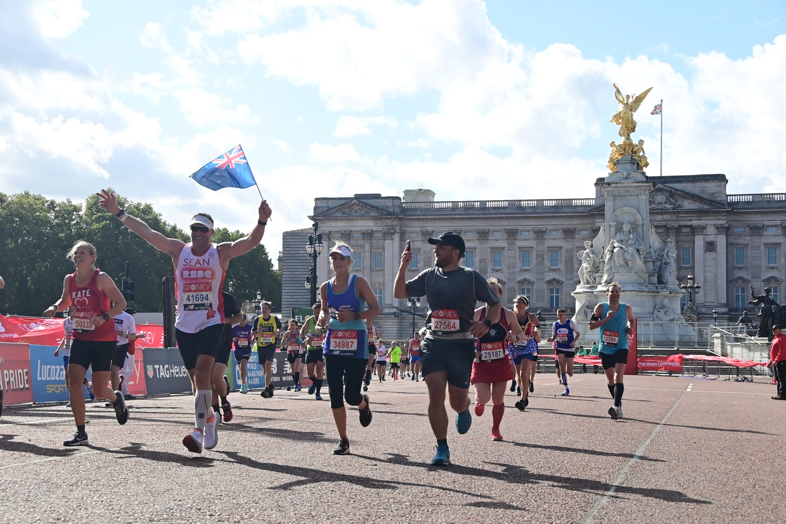 Sean running along the mall at London Marathon with Buckingham palace in the background.