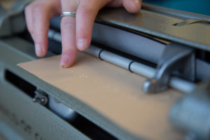 Hand touvhing braille letters