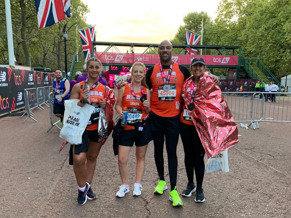 A group of 4 RSBC Runners smiling at the camera at the finish line of the 2022 London Marathon