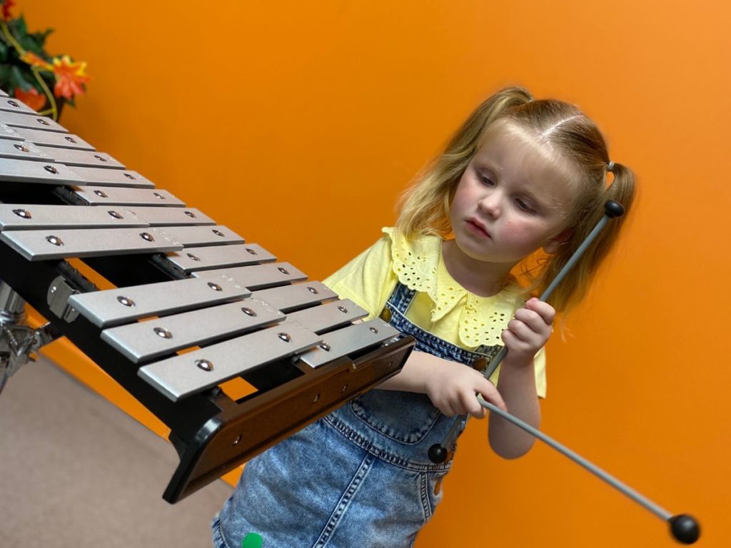 A little girl playing instrument