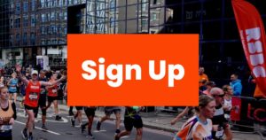 A photo of runners in the street with an orange graphic with white text that reads: "Sign up"