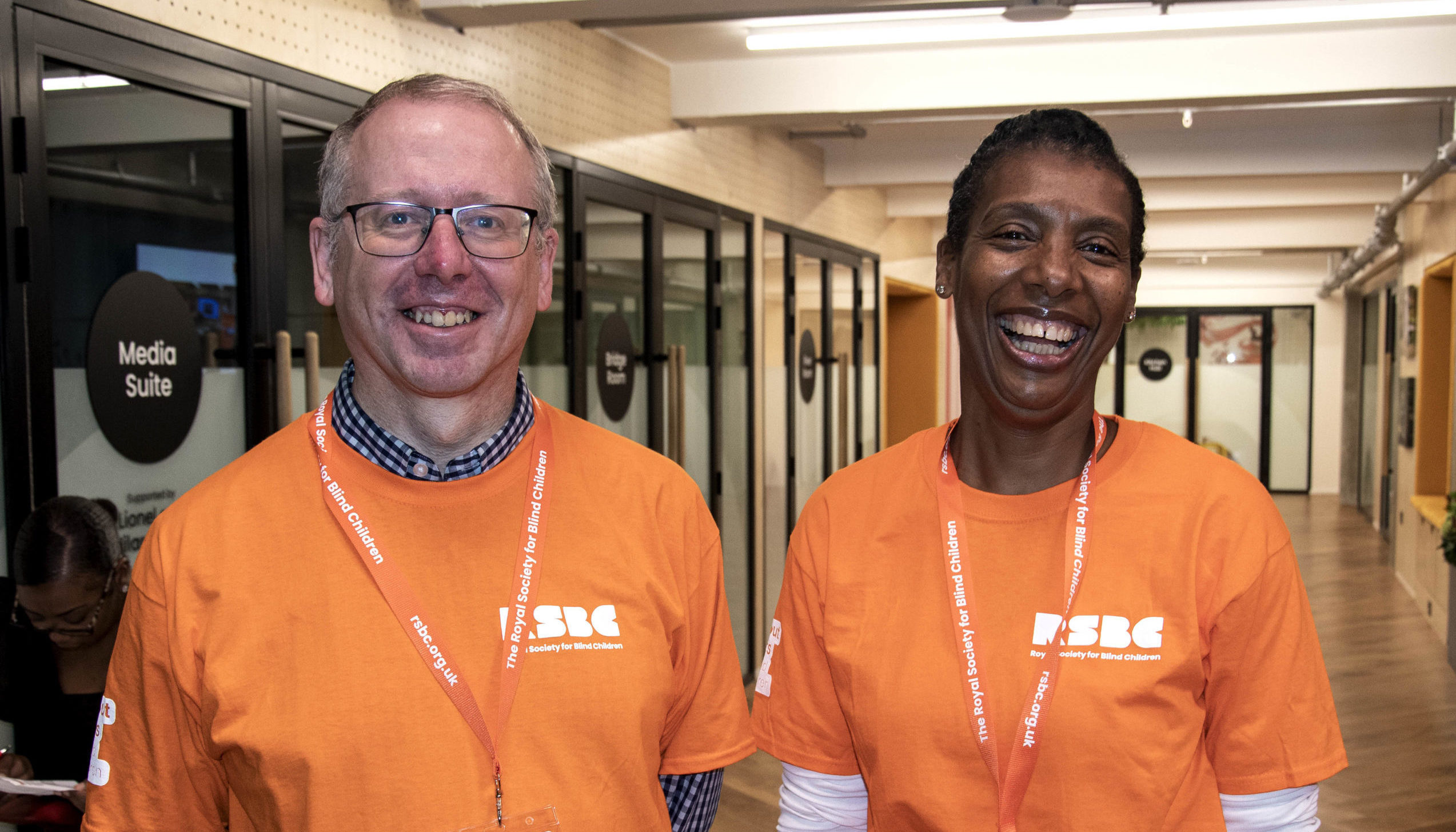 2 people smiling and wearing a RSBC volunteer t-shirt