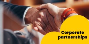 A yellow design with black text that reads: "Corporate partnerships" with a photo of a handshake in the background