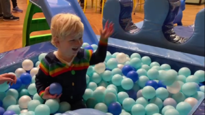 A child playing in a ball pit