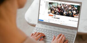 A person typing on a laptop with a screen showing the RSBC Connecting Parents Facebook Group