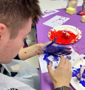A young person doing painting