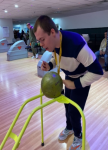 A young person playing bowling