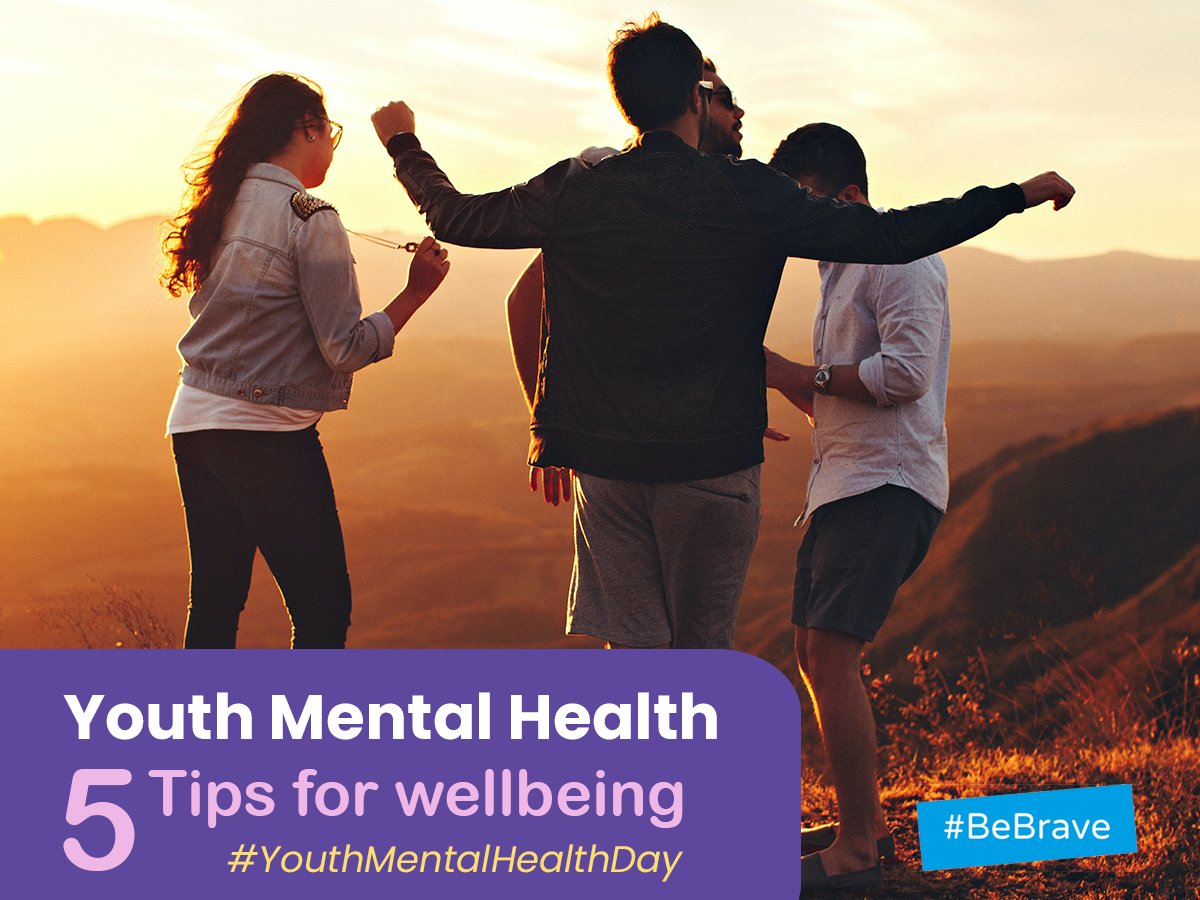 4 young people standing in circle in the middle of mountains with text that reads: "Youth Mental Health: 5 tips for wellbeing. #YouthMentalHealth.#BeBrave."