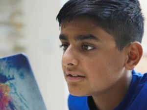 A boy looking at a tablet